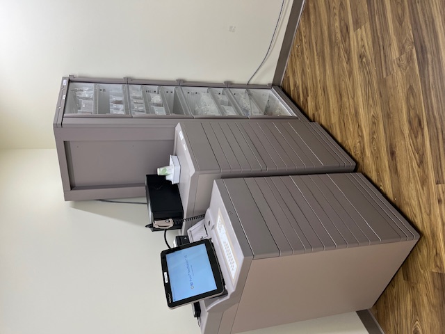 An image of two small cabinets and a large cabinet with a glass door, as new pharmacy equipment.