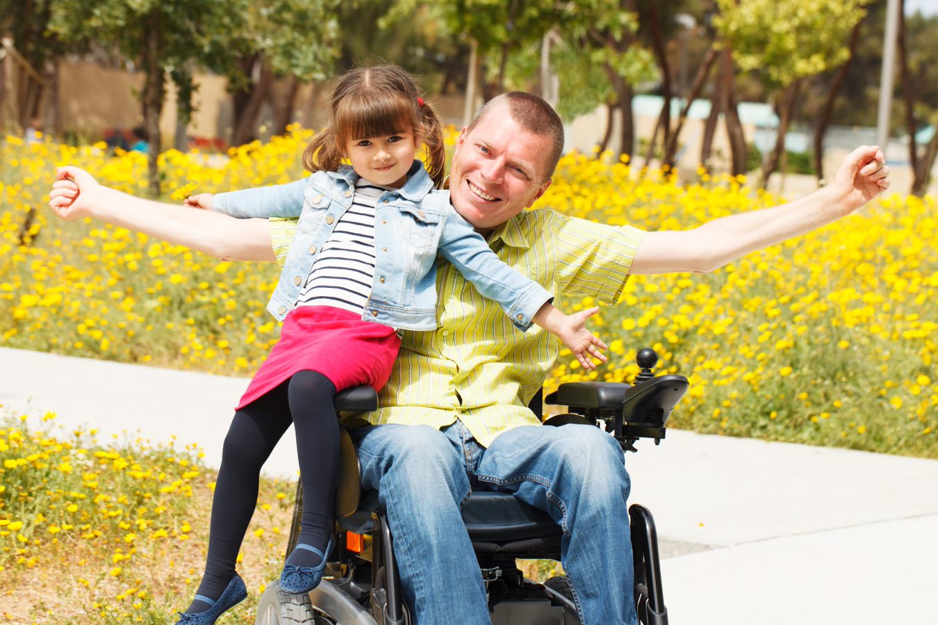 man in wheelchair with little girl