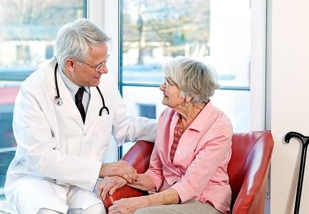 A doctor comforting an older woman 